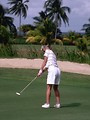 Free Stock Photo: A senior woman golfer on a tropical golf course by the ocean