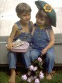 Free Stock Photo: A boy and girl holding roses and a box of chocolates