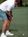 Free Stock Photo: A man bending over to putt a golf ball