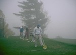Free Stock Photo: A group of seniors driving golf balls in the fog
