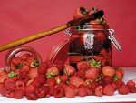 Free Stock Photo: A pile of strawberries and a jar of jam