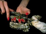 Free Stock Photo: Close-up of a woman opening an oyster