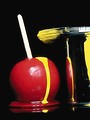 Free Stock Photo: Candy apple with yellow paint dripping on it