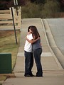 Free Stock Photo: A boy and girl hugging on the sidewalk