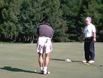 Free Stock Photo: A man watching another golfer putt