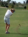 Free Stock Photo: A woman golfer swinging a golf club