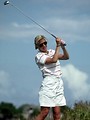 Free Stock Photo: An older woman golfer swinging a golf club