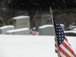 Free Stock Photo: Closeup of a US flag in a snow coverd graveyard