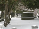Free Stock Photo: A snow covered tombstone in a graveyard.
