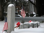 Free Stock Photo: US flags and tombstones in a snow coverd graveyard