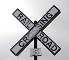 Free Stock Photo: A railroad crossing sign in a cloudy sky