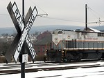 Free Stock Photo: A train passing by a railroad crossing sign
