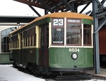 Free Stock Photo: A vintage green electric trolley parked in the snow