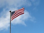 Free Stock Photo: A US flag flying in a blue sky