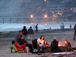 Free Stock Photo: People sitting by a campfire on the beach