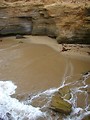 Free Stock Photo: A small beach by some rock cliffs