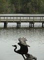 Free Stock Photo: A statue of a bird overlooking a bridge on water