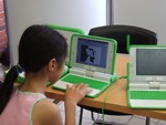 Free Stock Photo: Young girl using an OLPC laptop