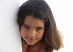 Free Stock Photo: Closeup of a young girl looking around a corner