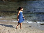 Free Stock Photo: A young girl walking along the beach