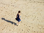 Free Stock Photo: A young girl walking on the beach