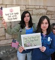 Free Stock Photo: Two young girls with signs and flags at the 2009 tax day tea party in Atlanta, Georgia