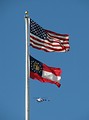 Free Stock Photo: A helicopter flying by a US and Georgia flag