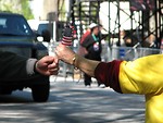 Free Stock Photo: A woman handing a man a US flag at the 2009 tax day tea party in Atlanta, Georgia