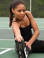 Free Stock Photo: A beautiful African American teen girl stretching on a tennis court