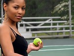 Free Stock Photo: A beautiful African American teen girl on an tennis court with a tennis ball