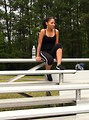 Free Stock Photo: A beautiful African American teen girl sitting on bleachers with a bottle of water