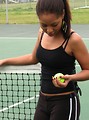 Free Stock Photo: A beautiful African American teen girl on an tennis court with a tennis ball