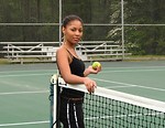 Free Stock Photo: A beautiful African American teen girl on an tennis court with a tennis ball