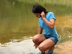 Free Stock Photo: A beautiful African American teen girl posing near a lake
