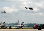 Free Stock Photo: AH-1F Cobra attack helicopters flying in the sky over a runway with Thunderbird jets