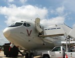 Free Stock Photo: Front view of a military plane on the runway with truck mounted passenger stairs