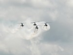 Free Stock Photo: Four AH-1F Cobra attack helicopters flying with smoke trails in the sky