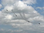 Free Stock Photo: Four AH-1F Cobra attack helicopters flying with smoke trails in the sky
