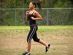 Free Stock Photo: A beautiful teen African American girl running by a fence