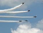 Free Stock Photo: Vintage SNJ-2 WW2 fighter planes flying in formation with smoke trails