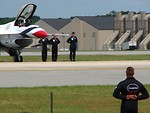 Free Stock Photo: An F-16 Air Force Thunderbird jet with crew members on a runway at the 2009 Robins AFB Air Show.