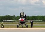 Free Stock Photo: An F-16 Air Force Thunderbird jet with crew members on a runway at the 2009 Robins AFB Air Show.