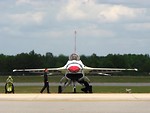 Free Stock Photo: An F-16 Air Force Thunderbird jet with crew members on a runway at the 2009 Robins AFB Air Show.