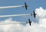 Free Stock Photo: Vintage SNJ-2 WW2 fighter planes flying in formation with smoke trails