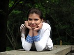 Free Stock Photo: A young girl posing on a stone wall