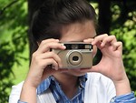 Free Stock Photo: Close-up of a young girl taking a picture with a camera