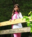 Free Stock Photo: A beautiful young punk rock girl looking over a wooden fence