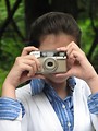 Free Stock Photo: Close-up of a young girl taking a picture with a camera