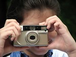 Free Stock Photo: Close-up of a young girl taking a picture with a camera