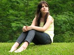 Free Stock Photo: A beautiful young girl sitting in the grass